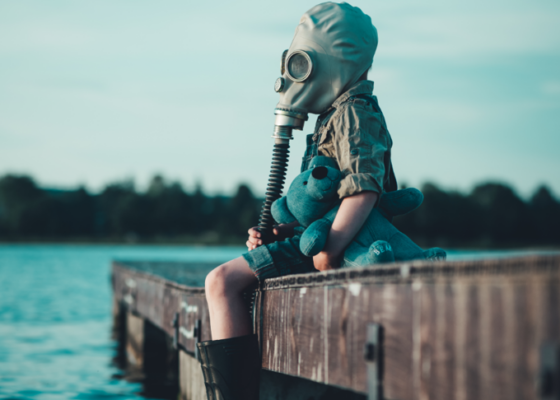 The danger of greenwashing message a child in a gas mask